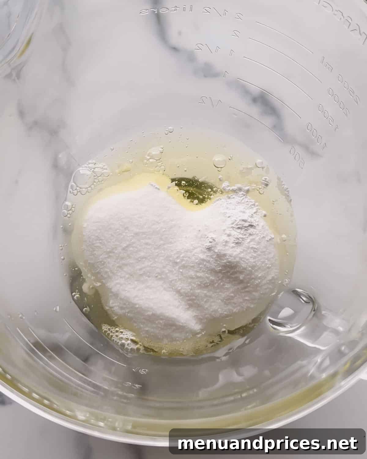 Minty Cocoa Macaron Bliss 5 Egg whites, sugar, cream of tartar, and salt are carefully measured into a clear glass mixing bowl, ready for whipping into a pristine meringue.