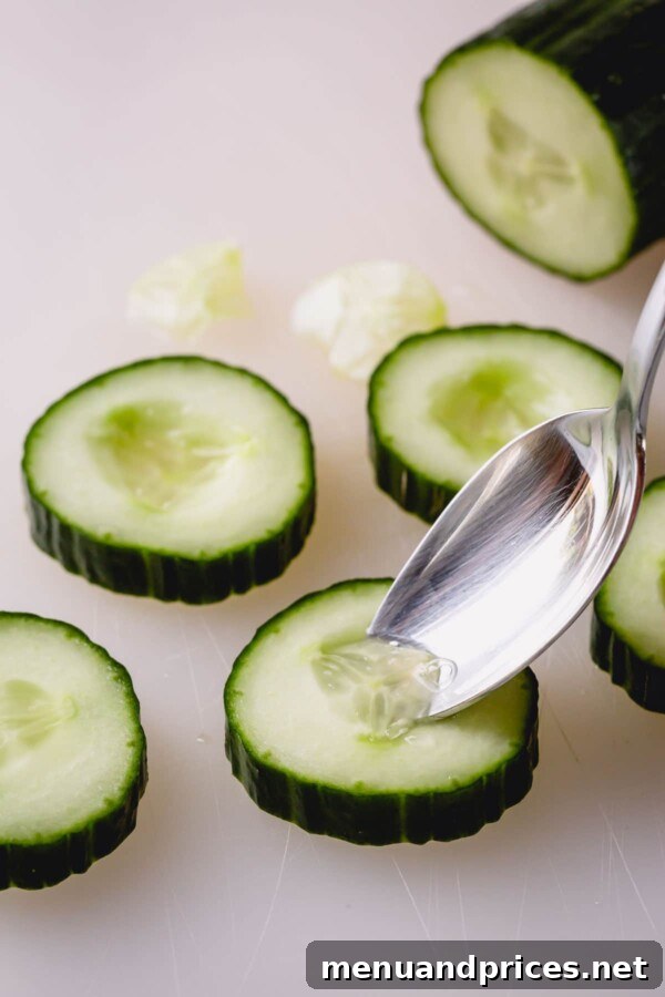 Crisp Cucumber Smoked Salmon Delights 3 Close-up of cucumber slices with a small hollow carved out of the center, ready for topping.