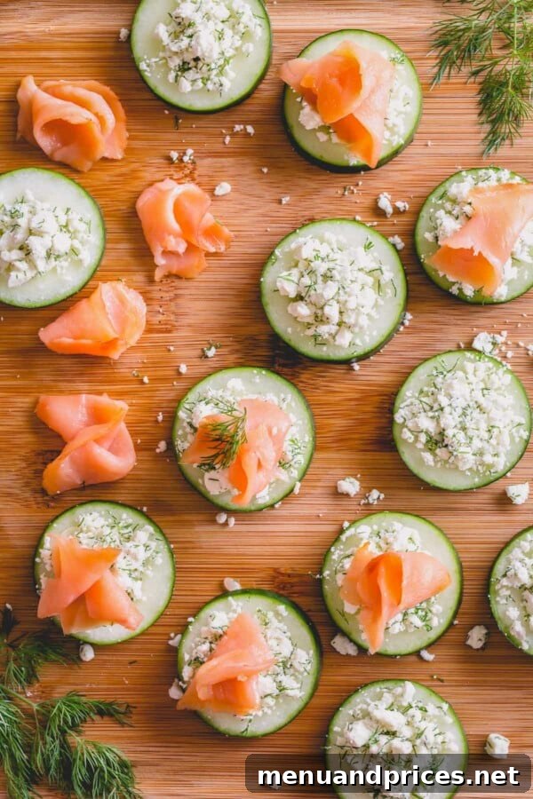 Crisp Cucumber Smoked Salmon Delights 4 Assembled smoked salmon cucumber bites featuring cucumber, feta, dill, and smoked salmon on a platter.
