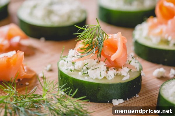 Crisp Cucumber Smoked Salmon Delights 5 A stunning close-up of a smoked salmon cucumber bite, showing the layers of crisp cucumber, creamy feta, and delicate smoked salmon, garnished with fresh dill.