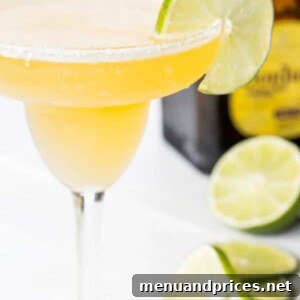 Delicious frozen beer margarita in a glass with an inverted Corona bottle