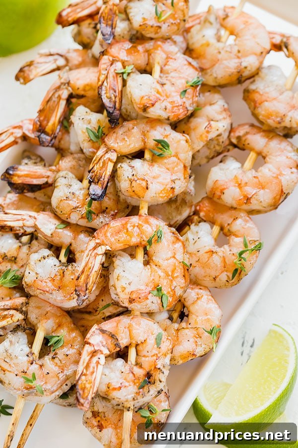 Tropical Jerk Shrimp Skewers 3 Perfectly grilled Jamaican Jerk shrimp skewers, an easy and delicious summer dinner idea. The succulent shrimp are marinated in authentic jerk seasoning for an unforgettable flavor. #grilledshrimp #jamaicanjerk #shrimprecipes