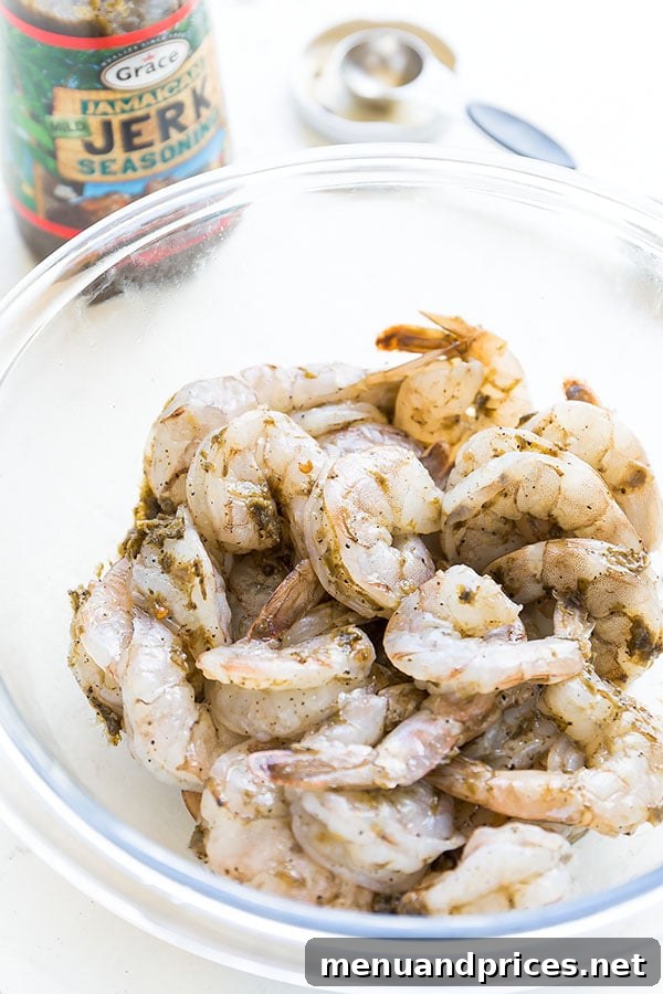 Tropical Jerk Shrimp Skewers 4 Beautifully grilled shrimp skewers, packed with flavor from Jamaican Jerk seasoning. A fast and easy recipe perfect for warm weather. #easydinner #appetizer #shrimpskewers #jamaicanjerkshrimp #grilledshrimp