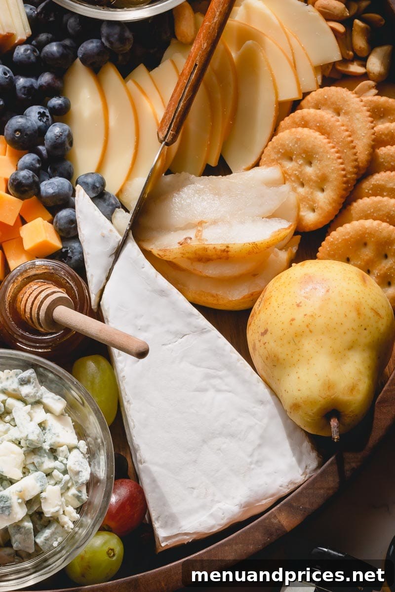 Cheeses arranged on a charcuterie board, from mild to strong.