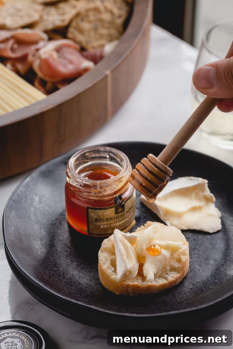 A vibrant assortment of accompaniments surrounding cheeses and meats.