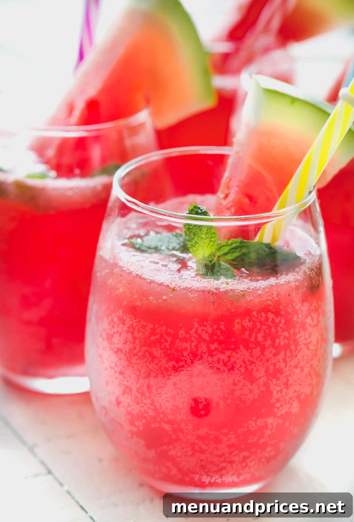 Watermelon Mint Chill 3 Close-up of Minty Watermelon Fizz with mint leaves and watermelon cubes at the bottom of a pitcher.