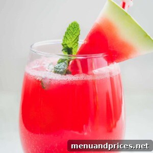 Minty Watermelon Fizz in a glass, with watermelon and mint garnishes.