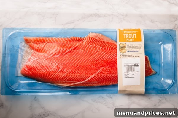 From Pink to King Exploring the Diverse World of Salmon 4 Close-up of a perfectly cooked salmon fillet, showcasing its flaky texture and rich color, garnished with fresh herbs.