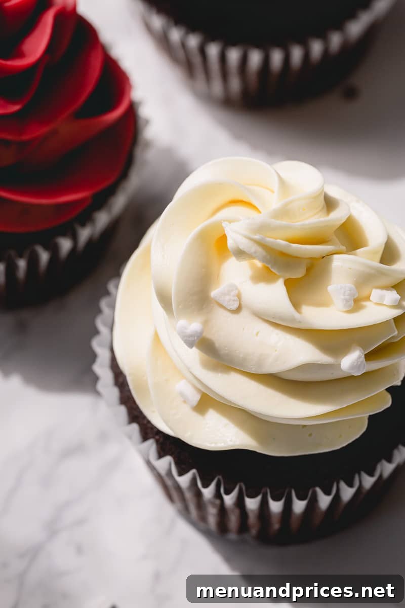 Crafting Silky White Chocolate Ganache 11 Chocolate cupcake frosted with tall whipped white chocolate ganache and white heart shaped sprinkles.