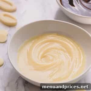 Crafting Silky White Chocolate Ganache 12 Glossy white chocolate ganache in a white bowl.