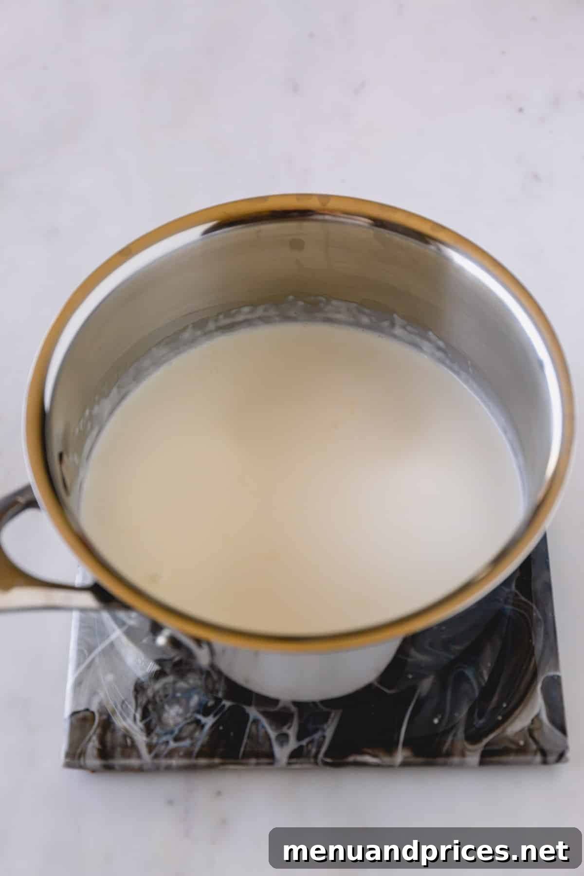 Crafting Silky White Chocolate Ganache 6 Cream in a small saucepan.