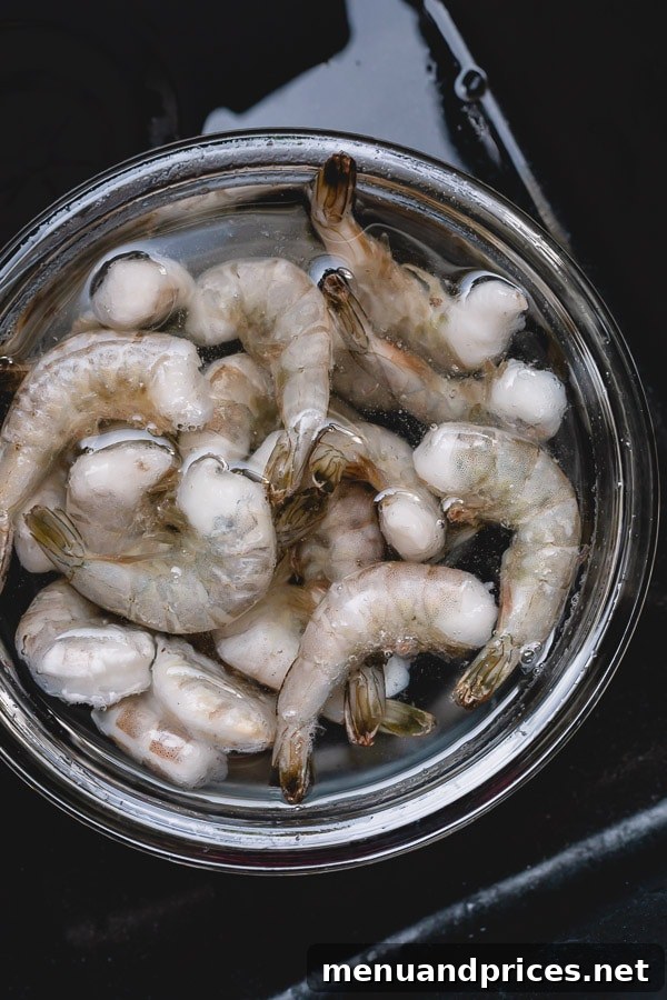 Perfectly Boiled Shrimp Every Time 4 Frozen shrimp rapidly thawing in a bowl of cold water.