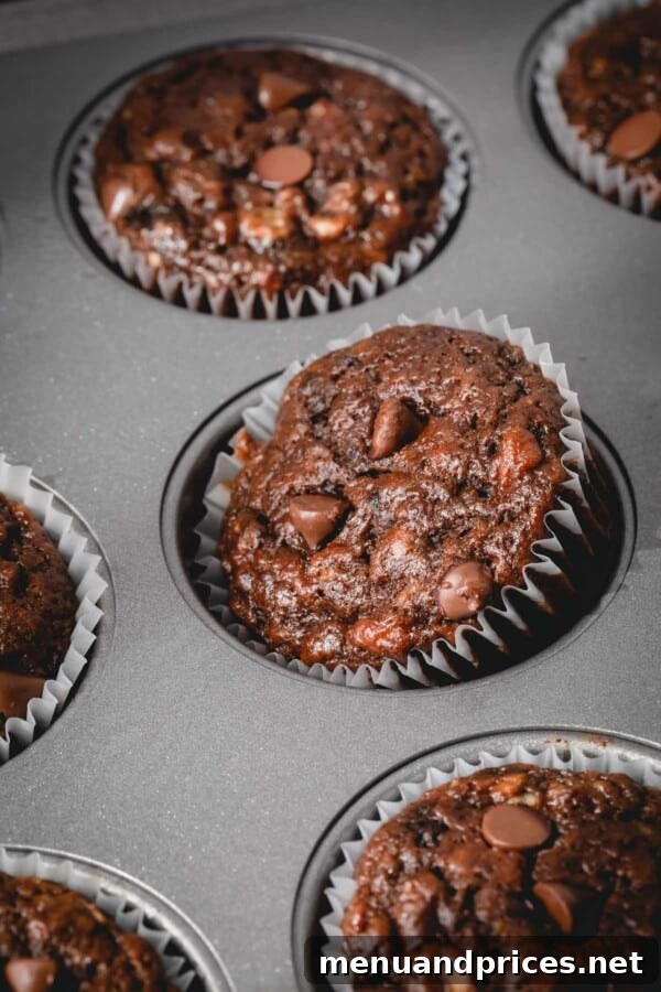 Fudgy Chocolate Banana Bread 8 Delicious chocolate banana muffins baked in a muffin tin, ready to be enjoyed.