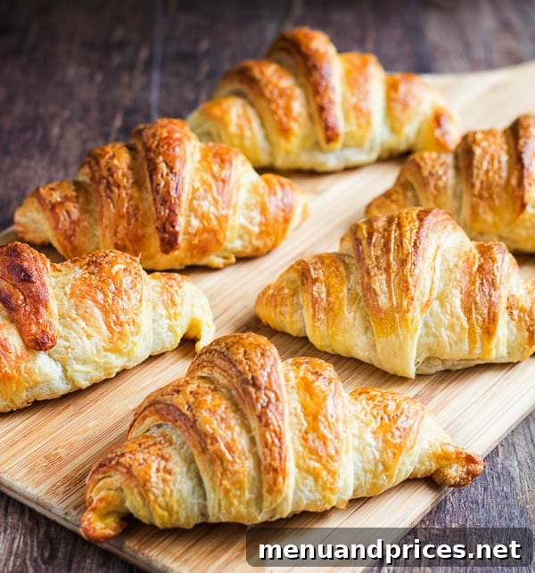 Flaky Homemade Croissants 10 A beautiful overhead shot of a batch of golden-brown homemade croissants, perfectly baked and showcasing their inviting texture and rich color.