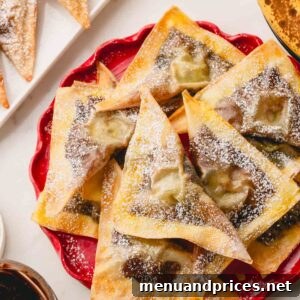 A plate of banana Nutella wontons dusted with powdered sugar, a perfect sweet treat.