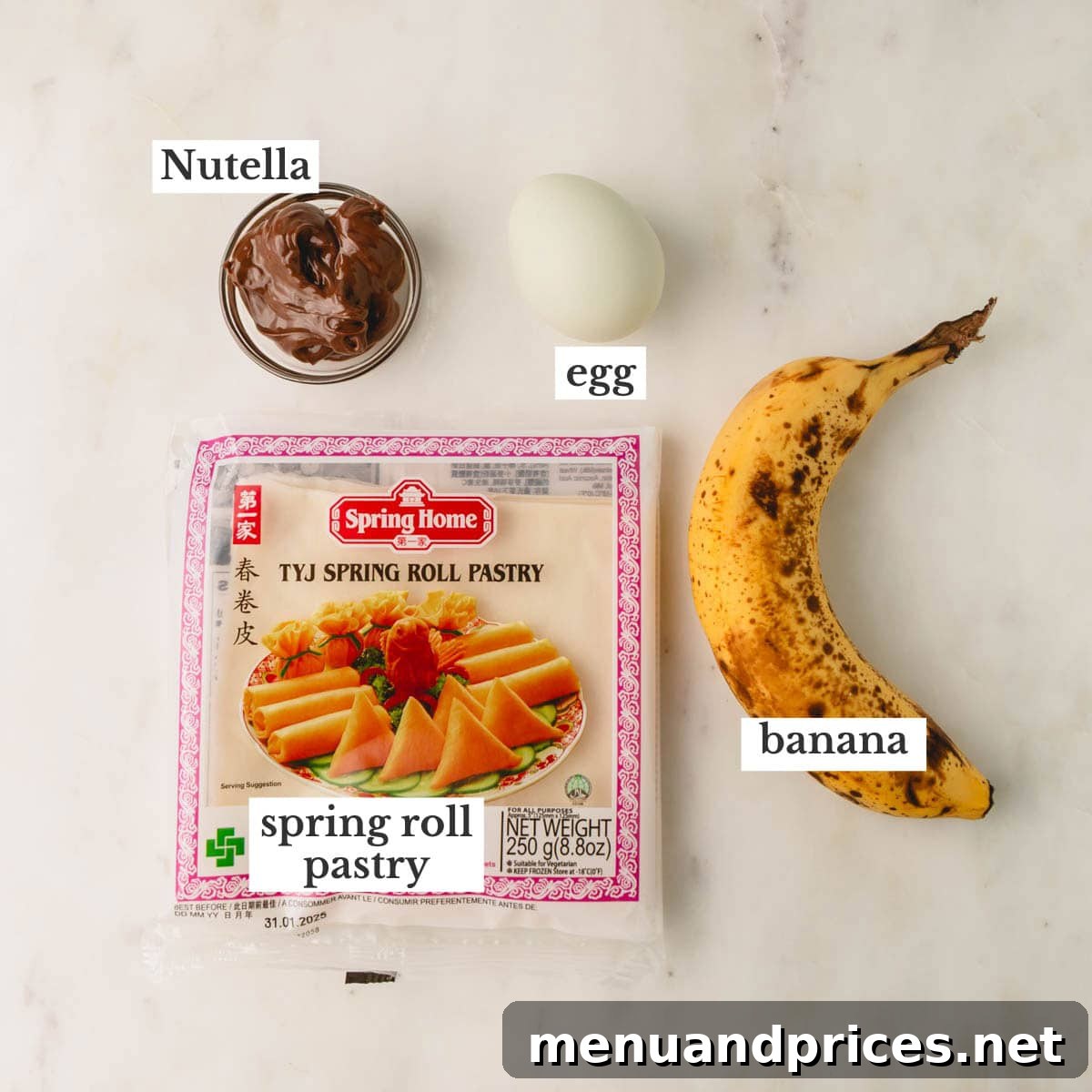 The essential ingredients laid out: a jar of Nutella, a fresh egg, a ripe banana, and a package of spring roll wrappers.