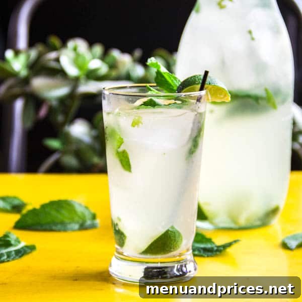 Tropical Bliss Coconut Mojito 3 Close-up of a classic mojito with a subtle coconut flavor, topped with ice, mint, and lime, ready for a refreshing summer drink.