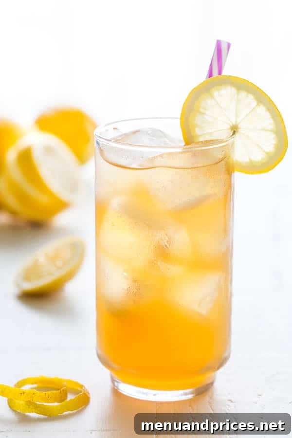Cool Earl Grey Refresher 2 A vibrant glass of homemade Earl Grey Iced Tea, garnished with fresh lemon slices and mint, against a bright background, perfect for a refreshing summer day.