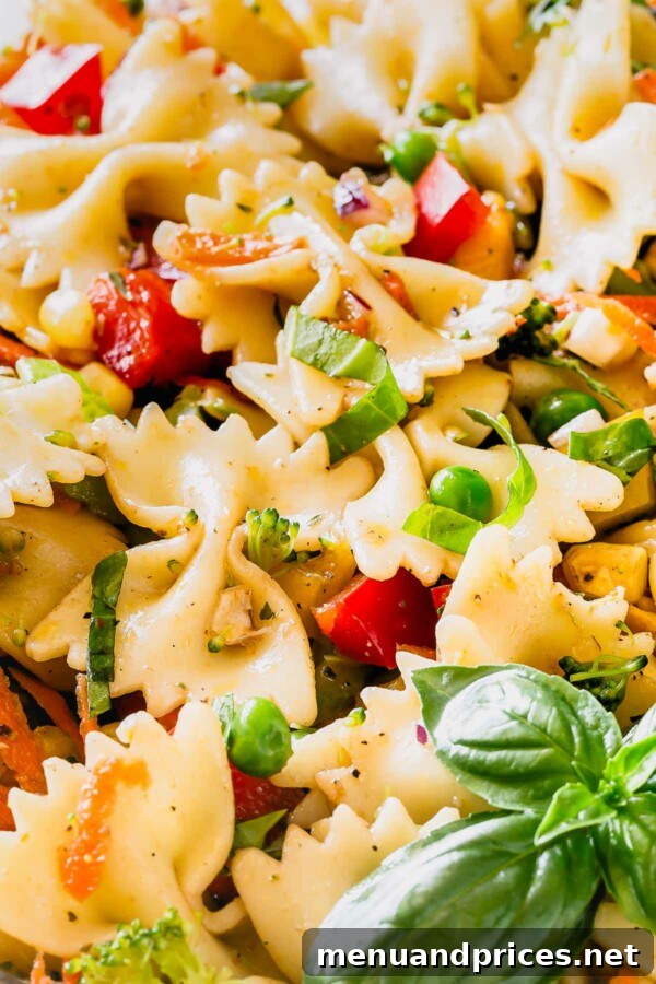 Vibrant Veggie Pasta Salad 2 A vibrant, colorful rainbow vegetable pasta salad in a large serving bowl, ready for a BBQ or summer meal.