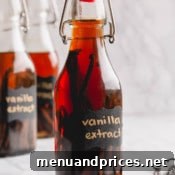 Homemade vanilla bean extract in a clear bottle.