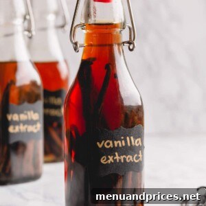 Homemade vanilla bean extract in a clear bottle, showcasing the vanilla beans.