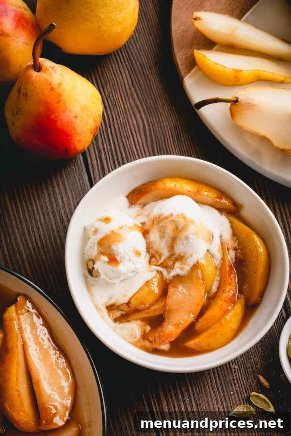 Golden Caramel Pear Bliss 3 Caramelized pear slices with a dollop of vanilla ice cream in a small white bowl.