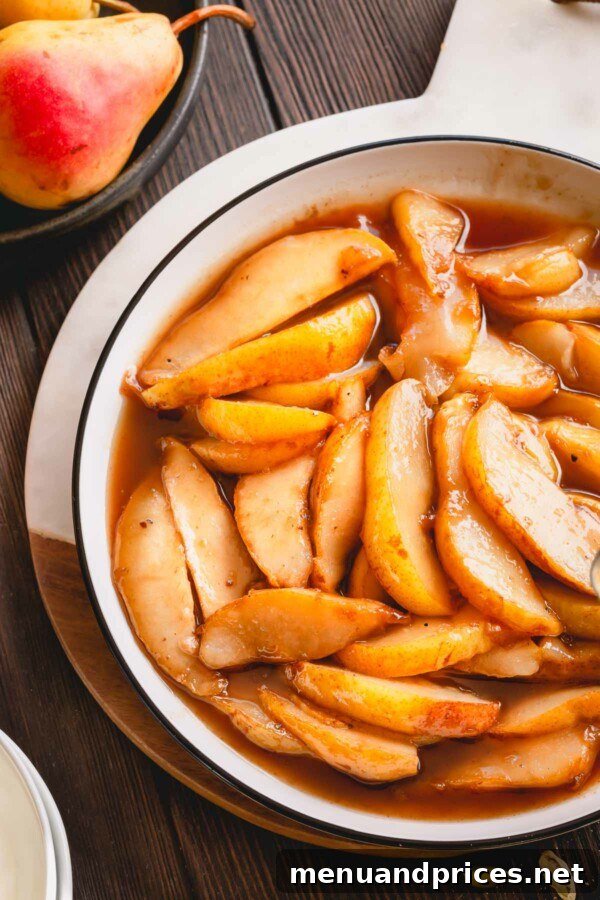 Golden Caramel Pear Bliss 4 Close-up of caramelized pear slices glistening with sauce on a white plate.