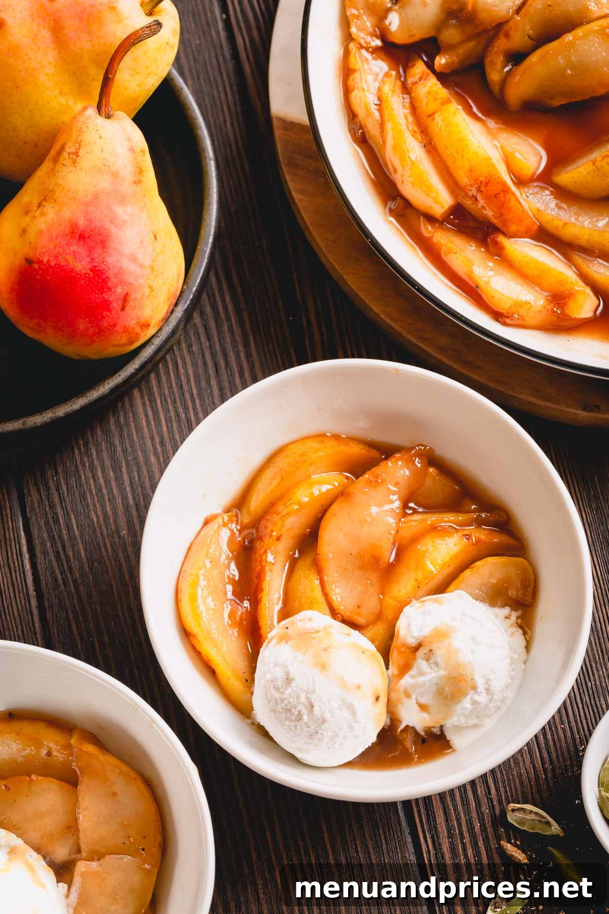 Golden Caramel Pear Bliss 6 Caramelized pear slices with a scoop of vanilla ice cream, artfully arranged in a small bowl.