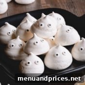 A final photo of a meringue ghost cookie, showcasing its crisp texture and cute details.