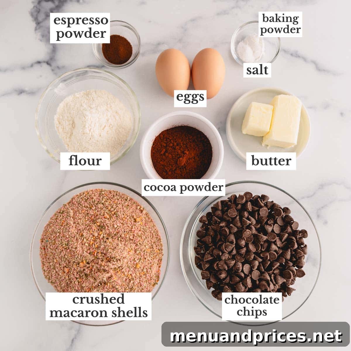 A display of all key ingredients for Macaron Brownie Cookies, including colorful macaron shells, cocoa powder, butter, and eggs, ready for preparation.