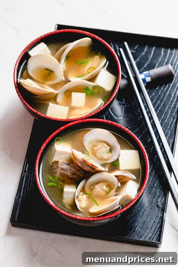 Umami Clam Miso 6 Two aesthetically pleasing bowls of clam miso soup, perfectly arranged on a black serving tray.