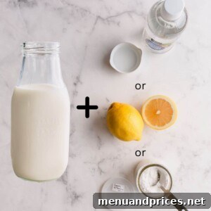 Bottle of milk with cream of tartar, white vinegar and lemon, representing buttermilk replacement ingredients.