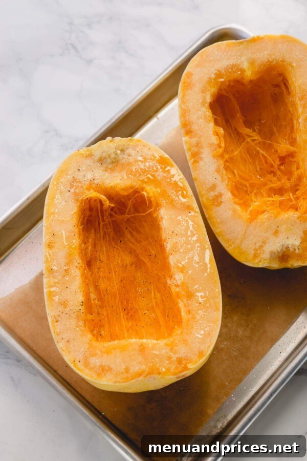 Master Spaghetti Squash Two Ways 4 2 halves of spaghetti squash on a baking sheet.