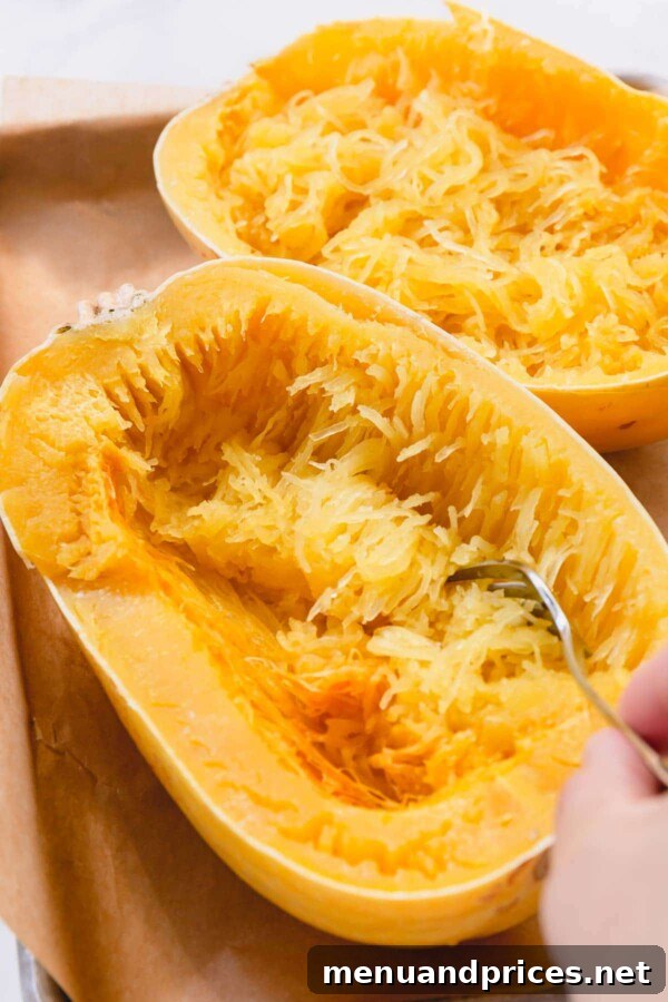 Master Spaghetti Squash Two Ways 5 Running a fork through a baked spaghetti squash.