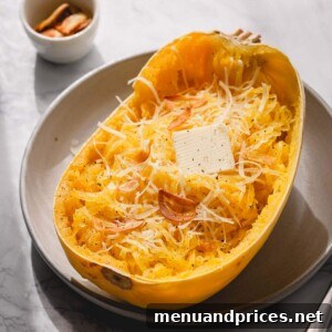 Half of baked spaghetti squash with butter and parmesan cheese.