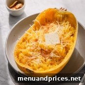 Half of baked spaghetti squash with butter and parmesan cheese.