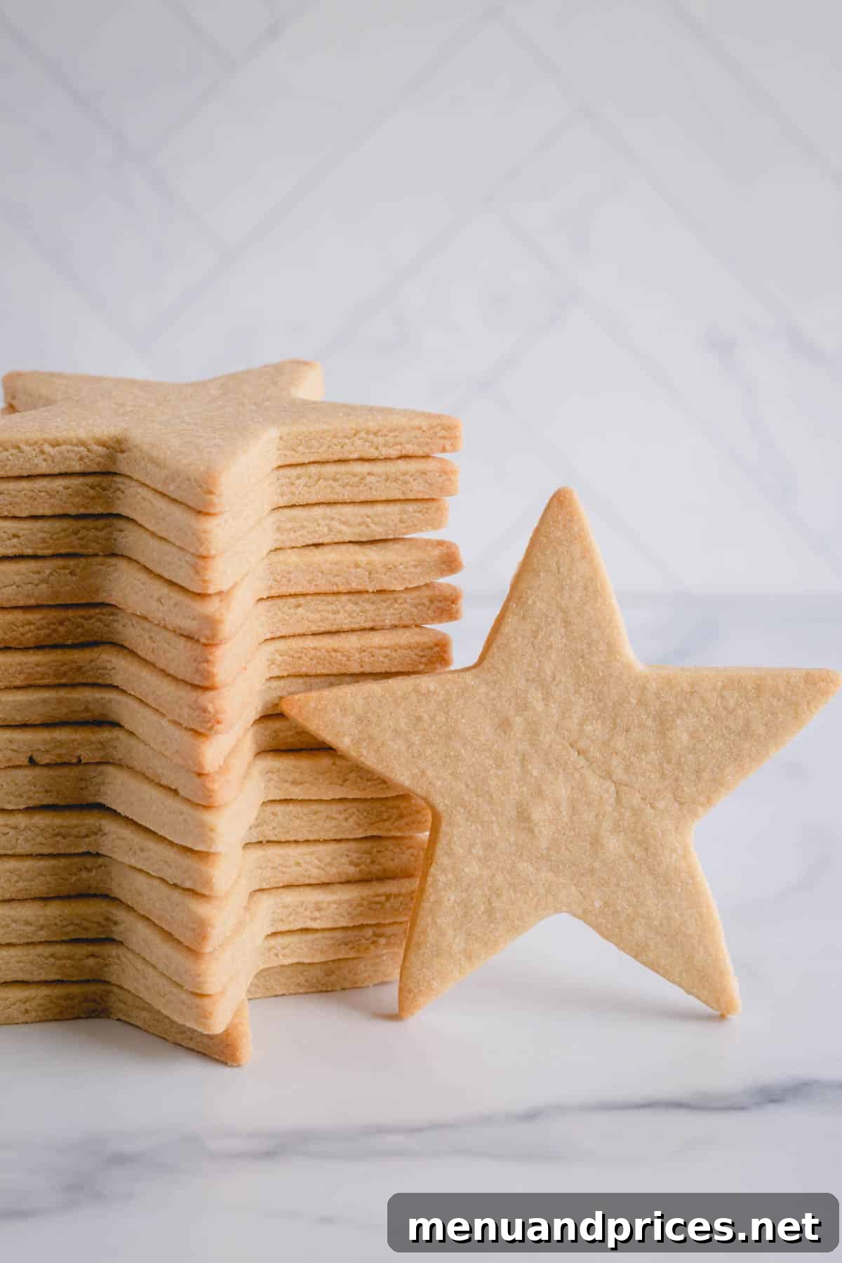 The Perfect No-Spread Sugar Cookies 2 One large star shaped sugar cookie standing against a stacked cookies.