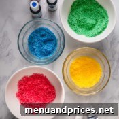 Whip Up Vibrant Homemade Sugars 7 A vibrant bowl of colored sugar with a spoon resting in it, ready for use in baking.