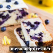 Another perspective of the finished blueberry lemon cake, showcasing its tempting glaze and golden-brown crust.