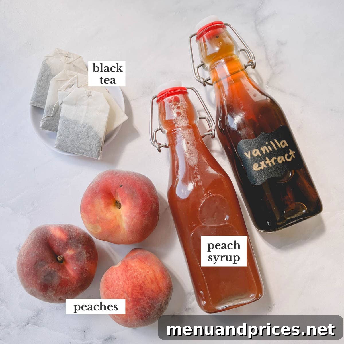 Golden Peach Chill 3 A selection of fresh peaches, granulated sugar, and black tea bags laid out as ingredients for peach iced tea.