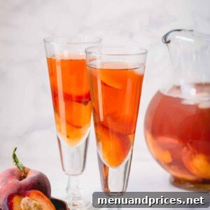 Golden Peach Chill 6 Two glasses of peach iced tea, garnished with peach slices and mint.