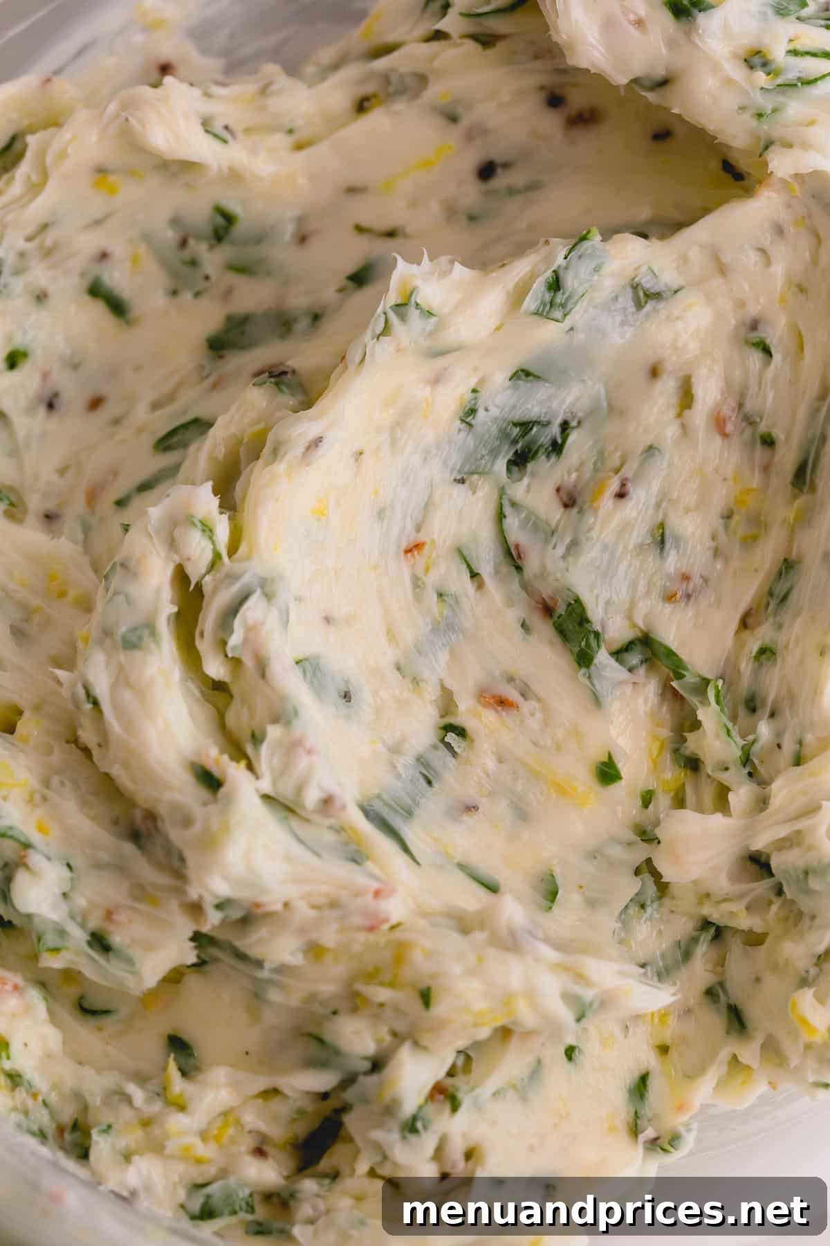 Unleash Flavor with Homemade Compound Butters 6 A close-up view of vibrant herb butter, highlighting its smooth texture and the fresh green specks of herbs.