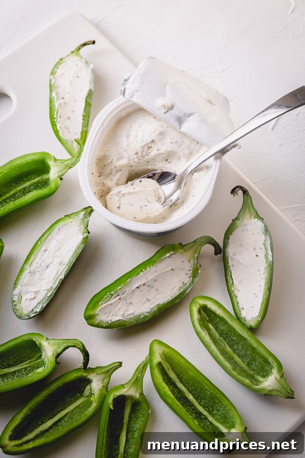 Jalapeno halves filled with a generous amount of creamy cheese.