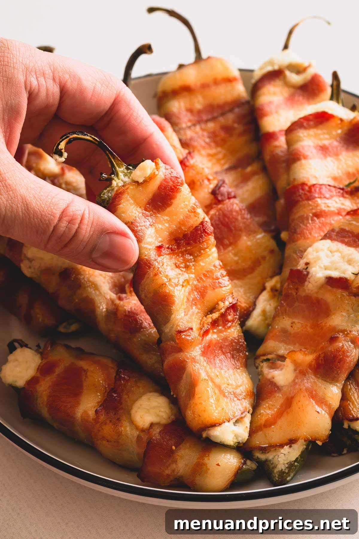 An inviting platter of crispy bacon-wrapped jalapeno poppers, garnished and ready to be enjoyed.