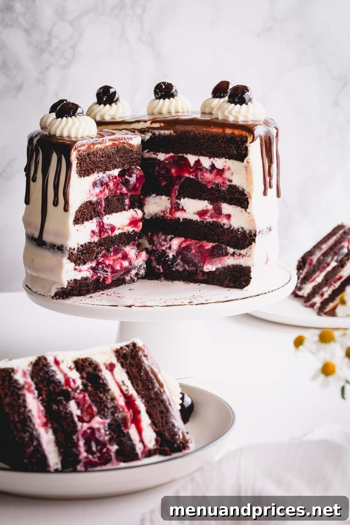 Decadent Black Forest Torte 8 A perfectly sliced Black Forest cake showing layers of chocolate, cherry, and white chocolate mousse on a white cake stand.