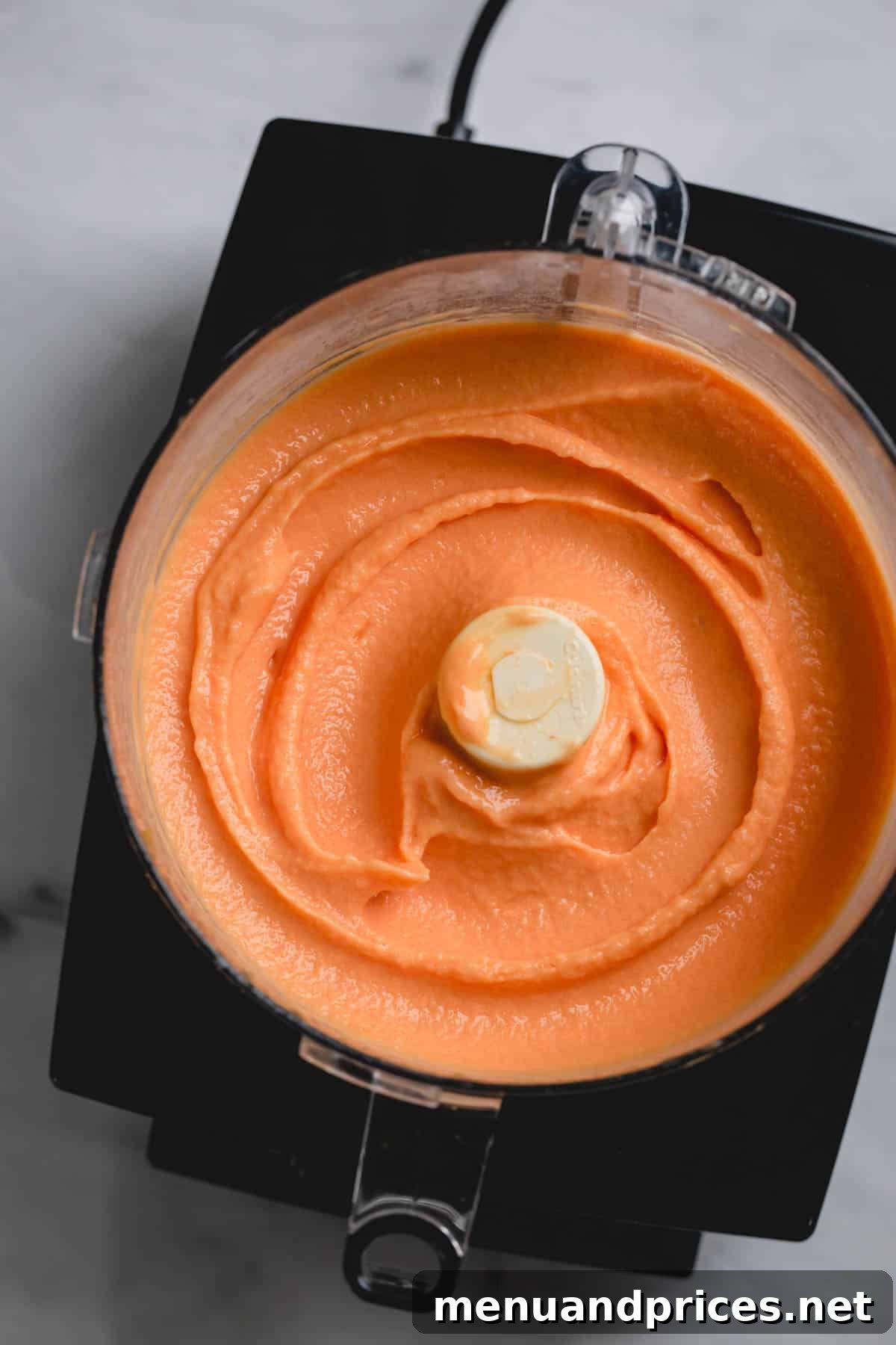 Velvet Peach Dream 2 Smooth peach ice cream in a large food processor, ready to be scooped.