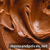 Upclose photo of smooth chocolate buttercream, indicating a delicious dessert.
