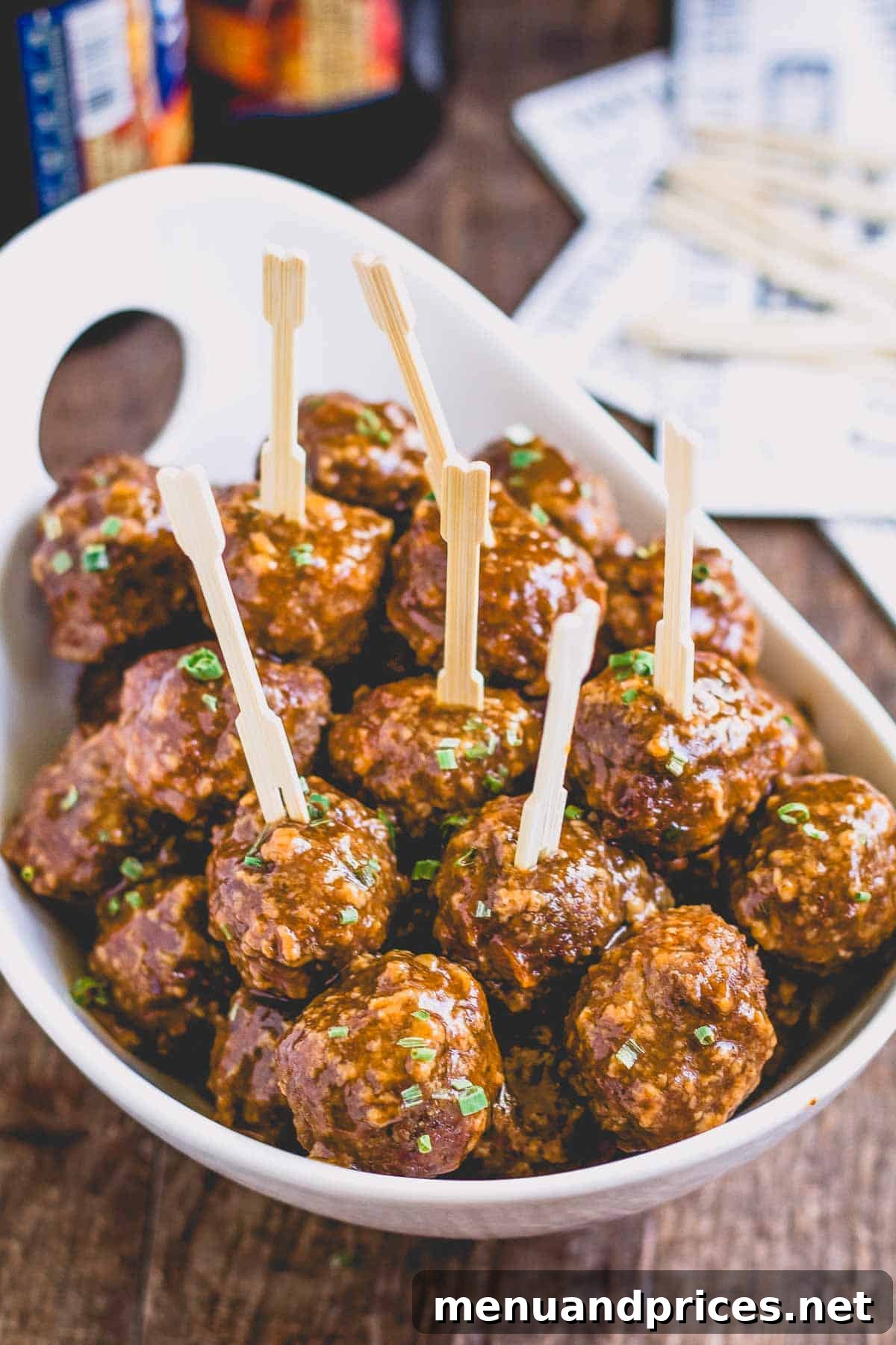 A beautifully presented bowl of Beer BBQ Meatballs with toothpicks, ready for serving.