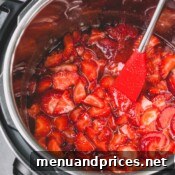 A jar of finished strawberry jam, ready for enjoyment.