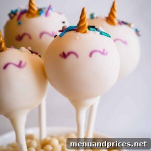 Unicorn cake pops elegantly displayed in a cup, showcasing their decorative appeal.